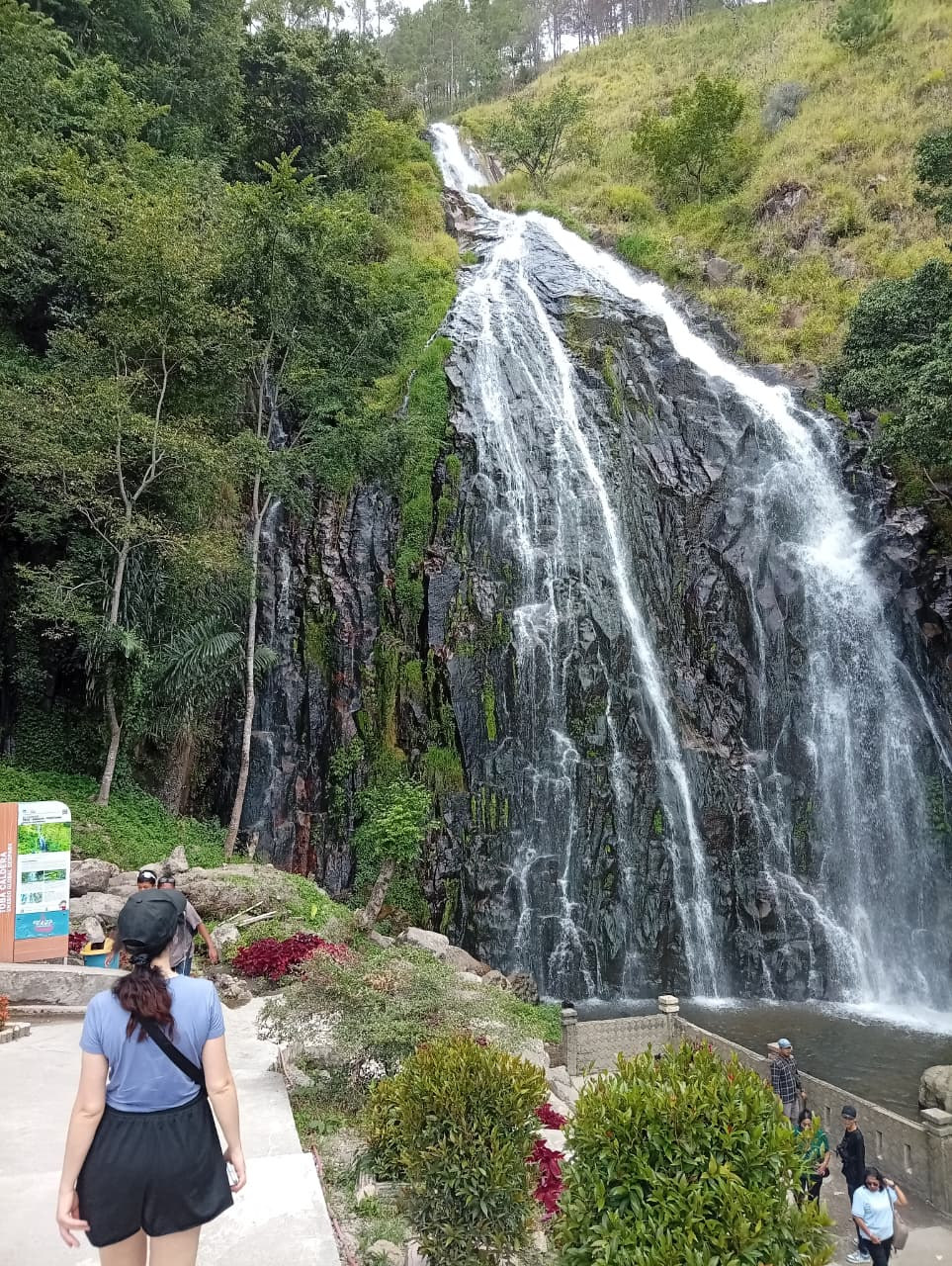 An adult guest enjoying the view at Sipiso-Piso Waterfall
